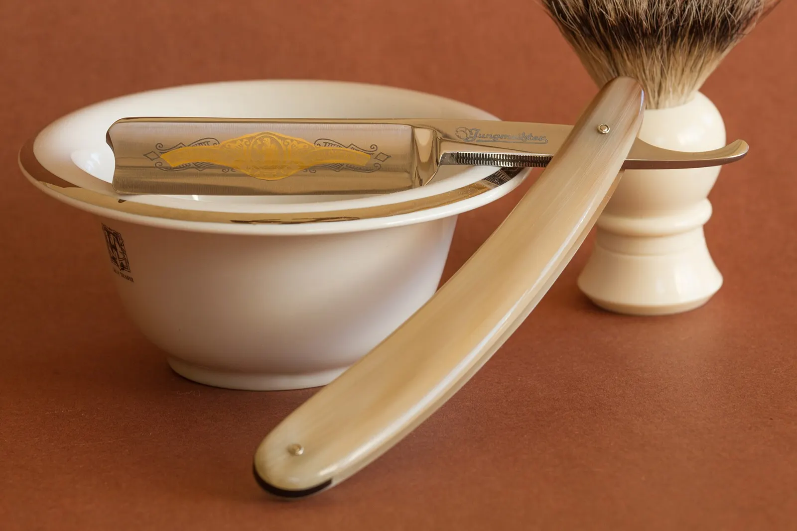 A straight razor, shaving brush and lather bowl